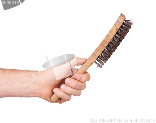 Image of Isolated steel brush in male hand
