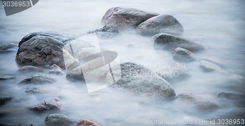 Image of Marine stones washed by a wave, close up