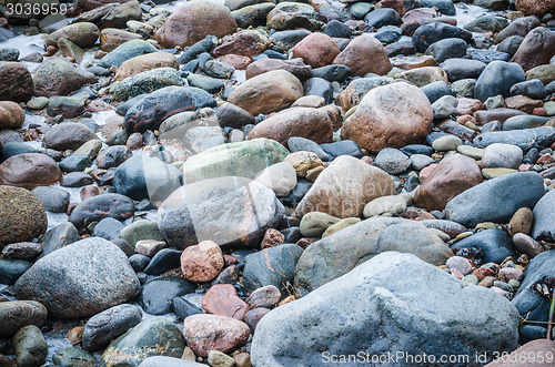 Image of The freezed stones on coast of Baltic sea. A winter landscape