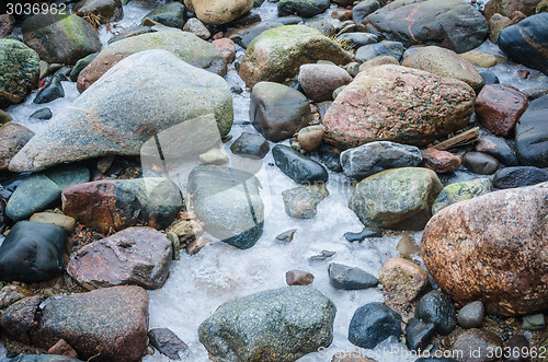 Image of The freezed stones on coast of Baltic sea. A winter landscape