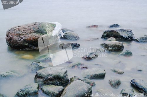 Image of Marine stones washed by a wave, close up