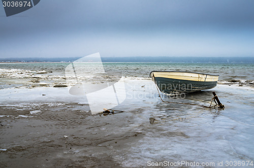 Image of Fishing boat on the shore of the Baltic Sea. Winter landscape