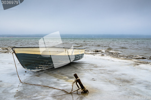 Image of Fishing boat on the shore of the Baltic Sea. Winter landscape