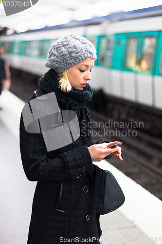 Image of Woman on a subway station.