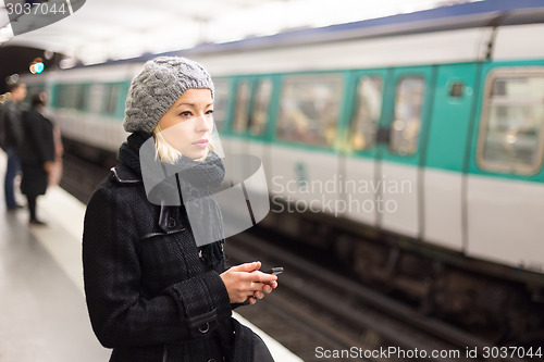 Image of Woman on a subway station.