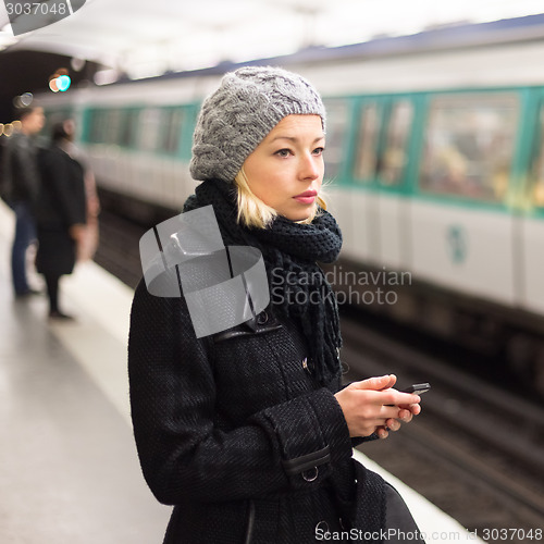 Image of Woman on a subway station.