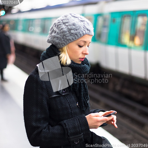 Image of Woman on a subway station.