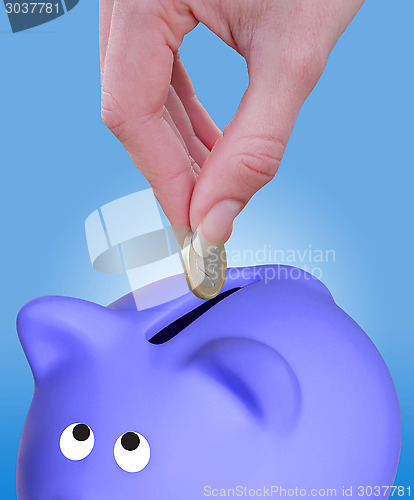 Image of Putting a coin euro in a piggy bank