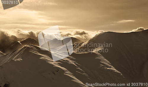 Image of Sepia mountains in mist at sun evening