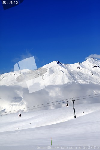 Image of Winter snowy mountains and cable car at nice day