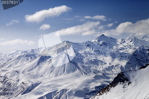 Image of Snowy winter mountains in sun day