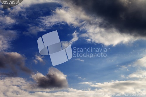 Image of Evening sky with sunlight and storm clouds