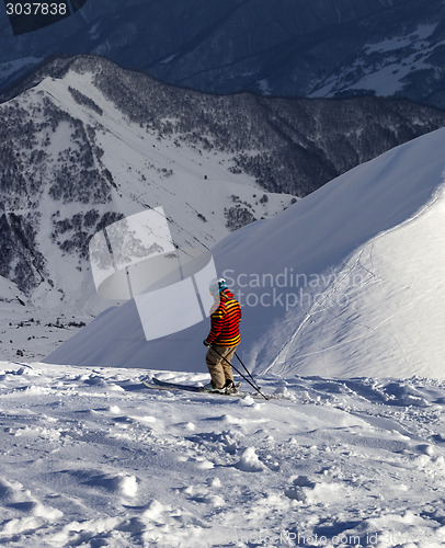 Image of Skier on off-piste slope in sun evening