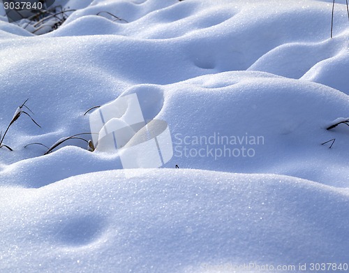 Image of Snow drifts in snowbound winter meadow 