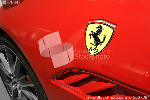 Image of Ferrari Horse Logo Close Up on Red Car 