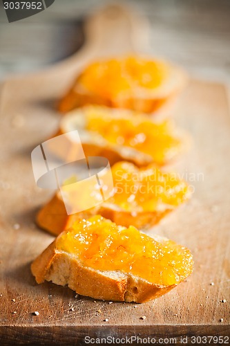 Image of pieces of baguette with orange marmalade