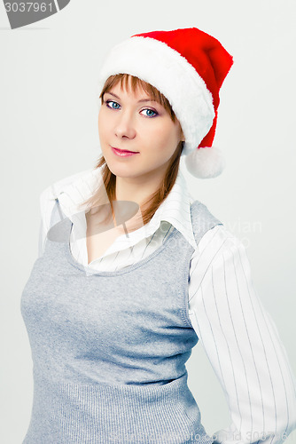 Image of Attractive girl in santa hat. Portrait