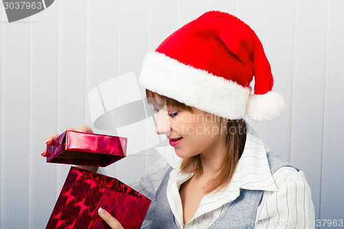 Image of girl in the office in Santa hats with a gift