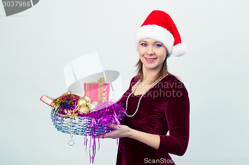 Image of happy girl in santa hat with gift boxes