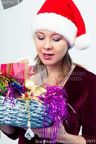 Image of happy girl in santa hat with gift boxes