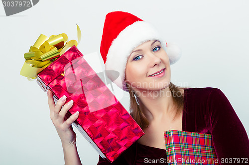 Image of happy girl in santa hat with gift boxes