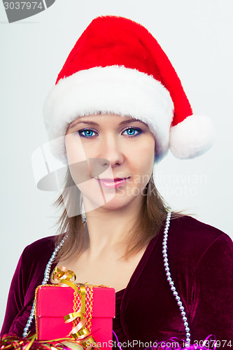 Image of happy girl in santa hat with gift boxes
