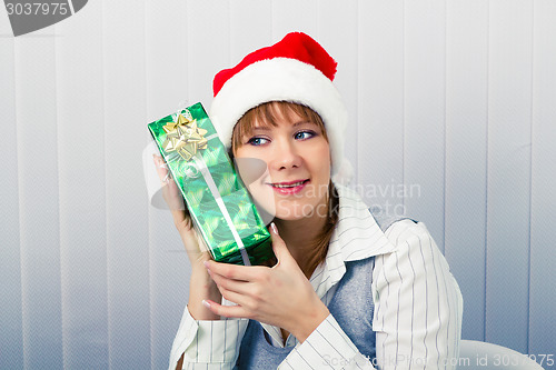 Image of girl in the office in Santa hats with a gift