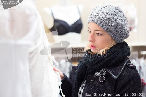 Image of Beautiful lady shopping in lingerie store.