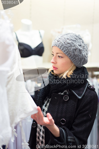 Image of Beautiful lady shopping in lingerie store.