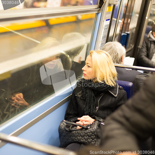 Image of Woman looking out metro's window.