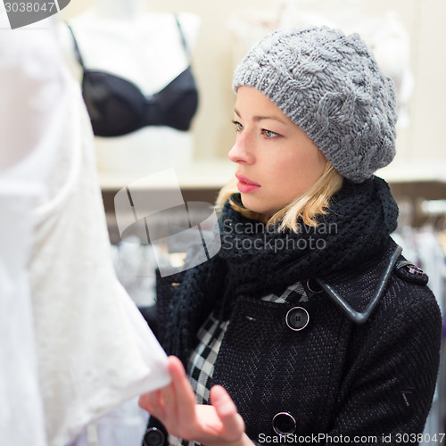 Image of Beautiful lady shopping in lingerie store.