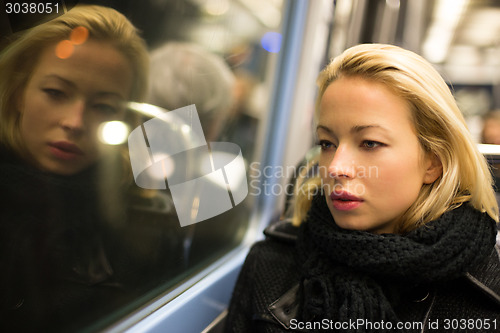 Image of Woman looking out metro's window.