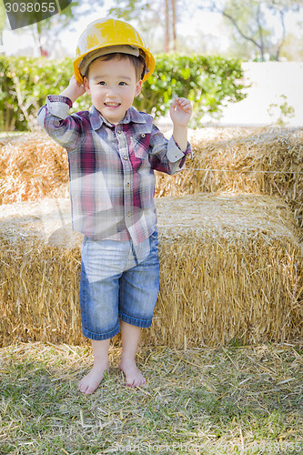 Image of Young Mixed Race Boy Laughing with Hard Hat Outside