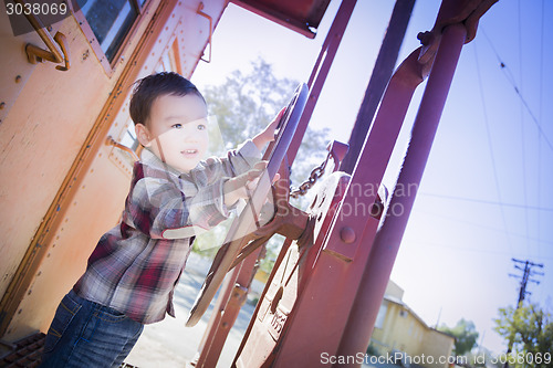 Image of Cute Young Mixed Race Boy Having Fun on Railroad Car