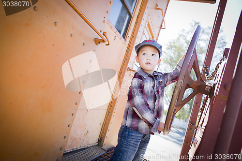 Image of Cute Young Mixed Race Boy Having Fun on Railroad Car