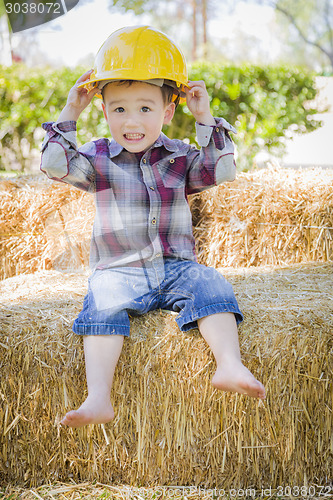 Image of Young Mixed Race Boy Laughing with Hard Hat Outside