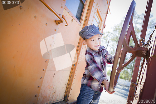 Image of Cute Young Mixed Race Boy Having Fun on Railroad Car