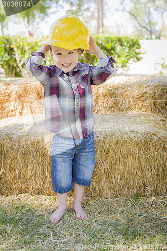 Image of Young Mixed Race Boy Laughing with Hard Hat Outside