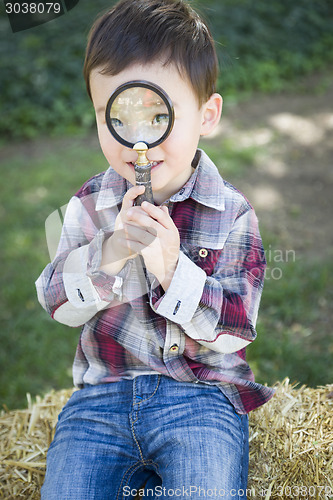 Image of Cute Young Mixed Race Boy Looking Through Magnifying Glass