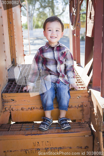 Image of Cute Young Mixed Race Boy Having Fun on Railroad Car