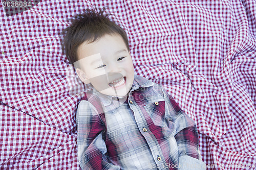 Image of Cute Young Mixed Race Boy Laughing On Picnic Blanket
