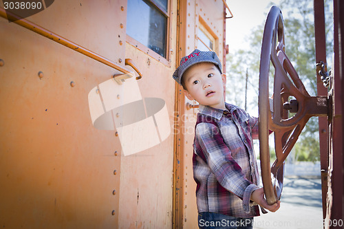 Image of Cute Young Mixed Race Boy Having Fun on Railroad Car