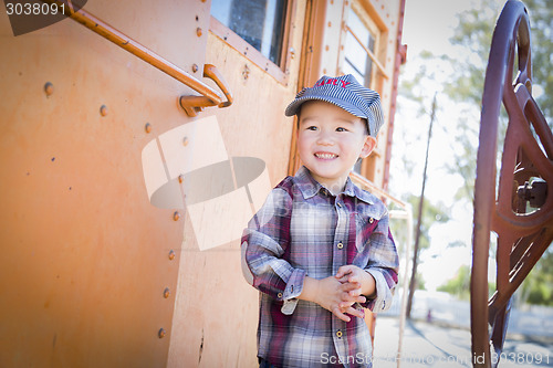 Image of Cute Young Mixed Race Boy Having Fun on Railroad Car