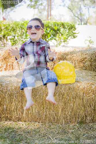 Image of Young Mixed Race Boy Laughing with Sunglasses and Hard Hat