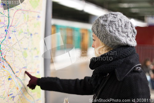 Image of Lady looking on public transport map panel.