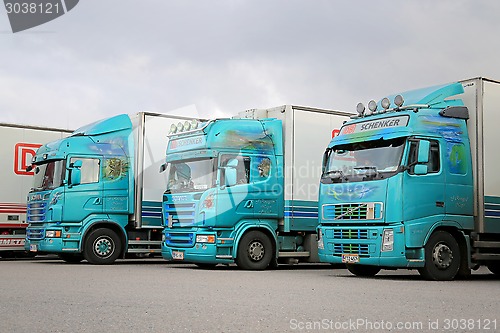 Image of Three Turquoise Trailer Trucks