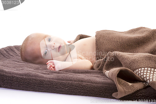 Image of baby boy over brown blanket 