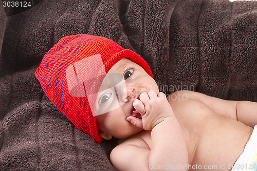 Image of baby boy over brown blanket