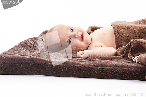Image of baby boy over brown blanket