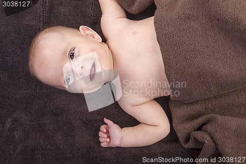 Image of baby boy over brown blanket